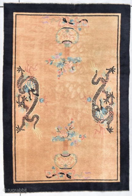 This late 19th century Peking Chinese Oriental Rug #8048 measures 5’3” X 7’11”. It has a sand colored background containing 2 facing dragons. Their scales are done in black. They have white  ...