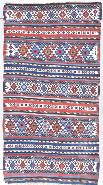 his late 19th century Caucasian Shirvan Kilim Oriental Rug #8013 measures 5’2” X 8’7”. It is woven in sparkling beautiful primary colors in a motif of stripes and bands with the background  ...
