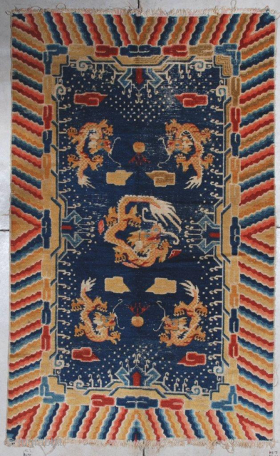 This late 19th century Ningxia Chinese oriental Rug #7118 measures 4’4’ x 7’0”. It has a navy blue ground with five dragons in yellow gold.   There are cloud motifs in  ...