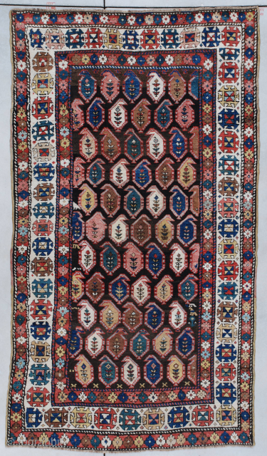 This circa 1890 Caucasian Kazakh #7320 carpet measures 4’4” x 7’6” (134 x 231 CM). It is multicolored on an abrashed brown field with lots of cute little asymmetric surprises in the  ...