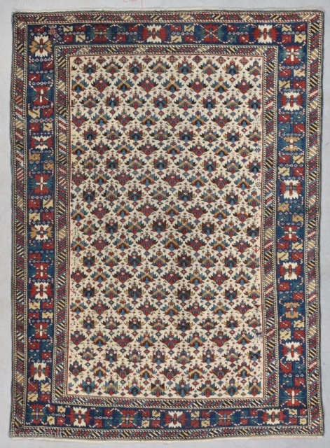 This antique Kuba Oriental Rug measures 3’8” X 5’1” (116 x 155 cm). It has an ivory ground completely covered in a combination of shield and palm head design with multi colored  ...