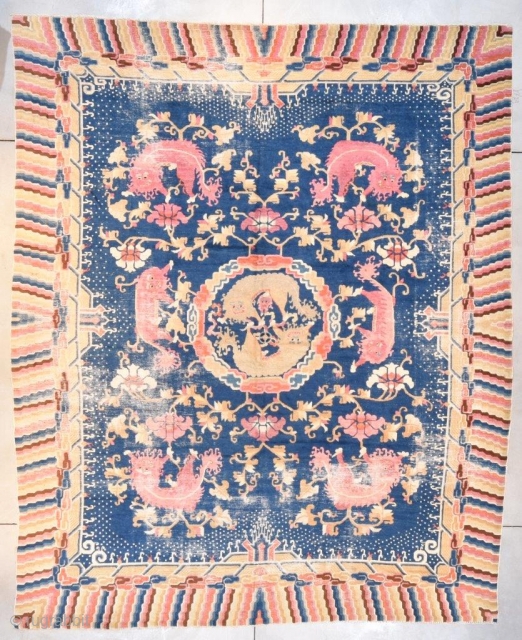 This Ningxia Rug #7654 measures 10’6” x 12’9” (323 x 393 cm). It has six foo lions cavorting among cloud symbols in white and Chinese brown. There are six peonies in pink  ...