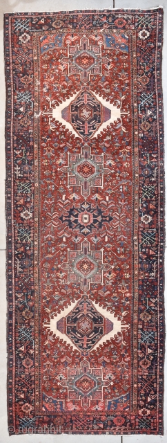 This circa 1920 Karaja runner #7969 measures 4’8” X 12’6”. It has seven medallions in ivory and teal on a tomato red ground with a combination floral and geometric motif. The two  ...