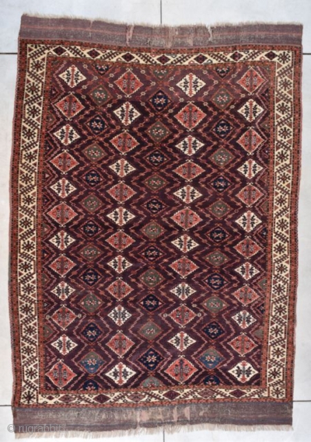 This circa 1860 Turkoman Chodor Oriental Rug measures 6’8” X 9’3” (203 x 282 cm). It has a medium to dark chocolate brown field with a diamond shaped motif in pale red,  ...