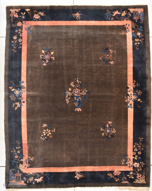 Antique Peking Chinese Rug  #7850

This antique Peking Chinese rug measures 9’0” X 11’5”. It has a deep chocolate brown field with five multi-colored flower sprays in the field, one of which  ...