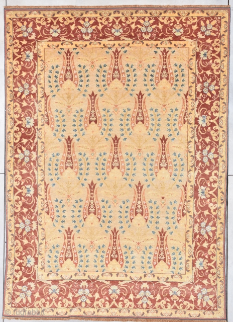 This circa 1910 Antique Turkish rug #7899 measures 8’0” X 11’4”. It has a whimsical repeated design on a butter yellow field offset with blue foliage surrounded with reciprocal  narrow golden  ...