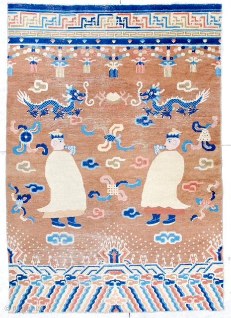 This third quarter 19th century Ningxia pillar rug #6692 measures 5’5” x 7’10”. It has two yellow robed monks blowing conch shell horns on a medium brown ground. The field motifs are  ...