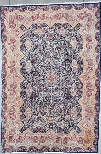 #7794 Kerman Oriental Rug
This antique Kerman Oriental Carpet which was bought new in 1927 measures 10’8” X 16’0”. It has a dark blue field with twelve flower filled cartouches which are on  ...