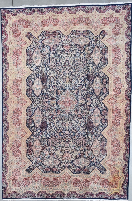 #7794 Kerman Oriental Rug
This antique Kerman Oriental Carpet which was bought new in 1927 measures 10’8” X 16’0”. It has a dark blue field with twelve flower filled cartouches which are on  ...