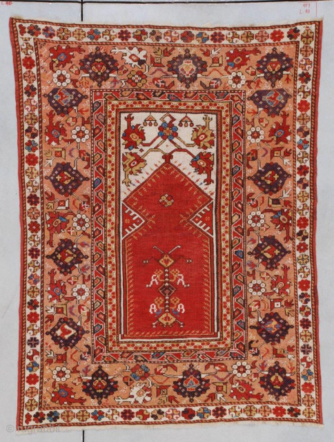 This circa 1825 Melas or Melez antique Oriental carpet #7177 measures 3’8” x 4’10”(115 x 152 cm). It has a tomato red prayer niche on an ivory ground with carnation motif in  ...