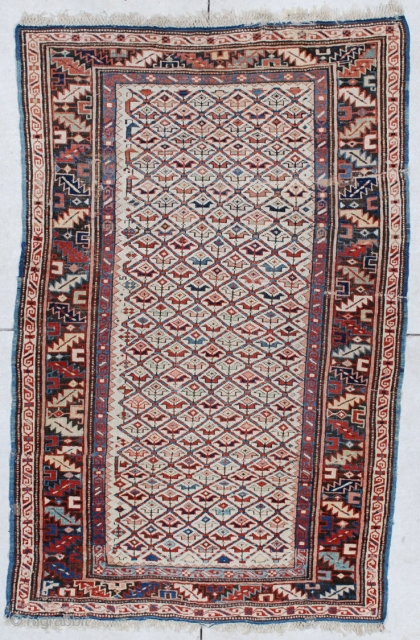 #6160 Kuba Antique Caucasian Rug 
This circa 1880 Kuba antique Oriental Rug measures 3’5” X 5’4”. It has a lattice design containing different colored flowers on an ivory field. The border is  ...