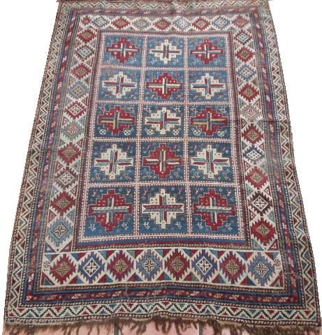 #6423 Shirvan Antique Caucasian Rug This circa 1870 Shirvan antique Oriental rug measures 4’0’ X 6’0’. It has fifteen panels with red and white medallions containing cross bars of ivory/blue , ivory/red  ...