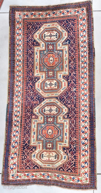 This second half 19th century Kazak antique rug #7732 measures 4’3” X 9’0” (131 x 274 cm). It has a double keyhole design. It is in full pile delicious condition except for  ...