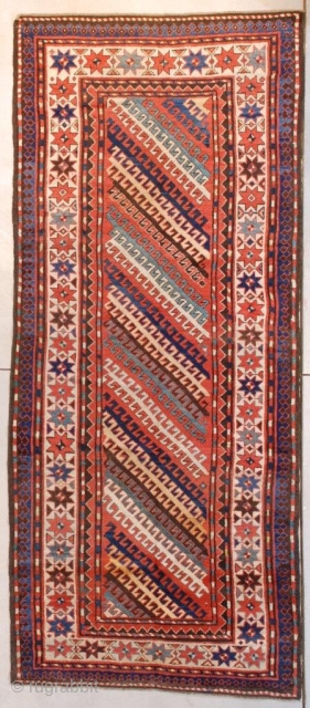 This circa 1870 Kazak antique Oriental rug runner #7586 measures 3’9” x 8’8” (118 x 268 cm). It is a very interesting Kazak. It has diagonal stripes in ivory, green, gold, brown  ...