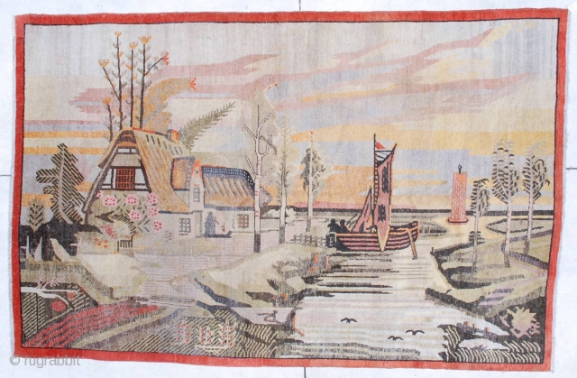 This circa 1920 antique Khotan rug #6795 measures 5 ‘10” x 9’ 0 “. It has a fantastically drawn scene of a house on the water with a lovely tiled roof sitting  ...