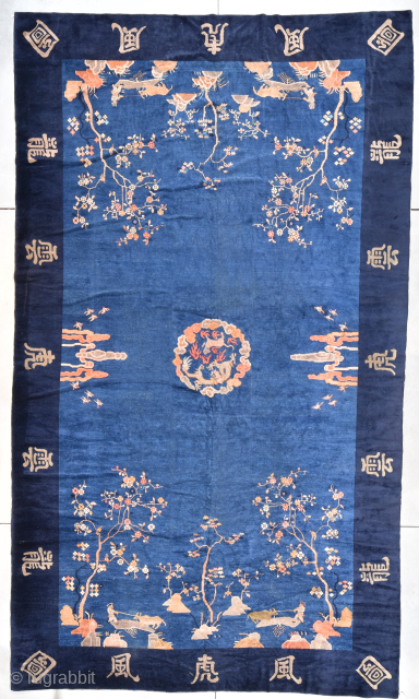 This circa 1890 Peking Chinese rug #6164 measures 10’2” X 17’3’. This beautiful gigantic rug has a small center medallion of a dragon in a standoff with a cow or dog all ...