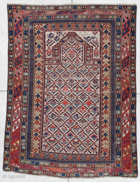 #6091 Marasali Shirvan This Marasali Shirvan rug measures 4’0” x 5’6”. It has a prayer design on an ivory field with a lattice design. Each opening in the lattice has a different  ...