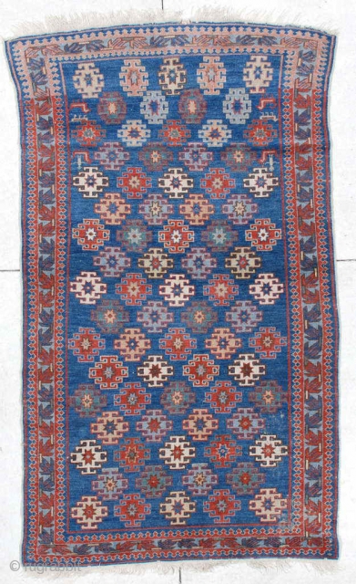 
#6471 Kuba Antique Caucasian Rug 
This 19th century antique   Kuba measures 3’9” X 6’4”. It has latch hook medallions in red, ivory, yellow, green and pale blue on a medium  ...