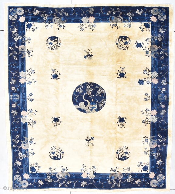 This late 19th century Peking Chinese Oriental rug #7896 measures 8’7” X 9’6”. It has four rondels containing and antlered animal under a tree and six flower sprays in two shades of  ...