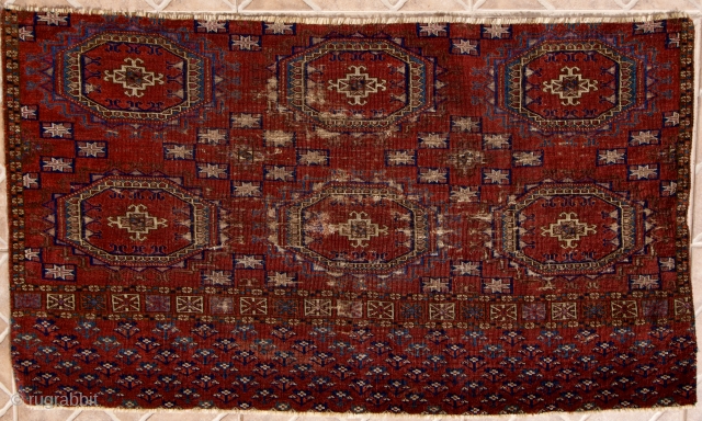 Exceptional fine and old Tekke chuval fragment. 100 x 58 cm. Before 1850. Six turreted Salor gul design with each gul outlined in indigo blue or blue-green. "Sarach-Palak" secondary gul with each  ...