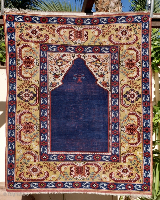 A fine and accurate reproduction of a 17 th. century "Transylvanian" prayer rug.  West Anatolian. 125 x 120 cm. The prayer niche with arabesque spandrels and a mustard yellow main border  ...