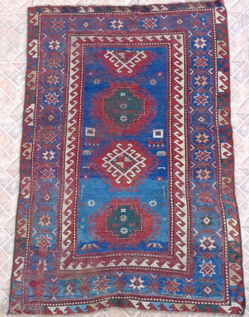 Bordjalou Kazak 215 x 112 cm (7.05ft x 3.7ft) with pre -1900 liveliness. The design with hooked diamonds and medallions on an abrashed blue ground. The field with animals, combs, herding sticks  ...