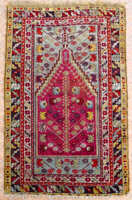 Kirshehir Prayer rug, 3 rd qtr. 19th. C.
Size: 5.4 x 3.4ft. Pale blue ground with a vivid cochineal purple-red mihrab.
Original double side cords.
Slight overall wear and a bit reduced at the lower  ...