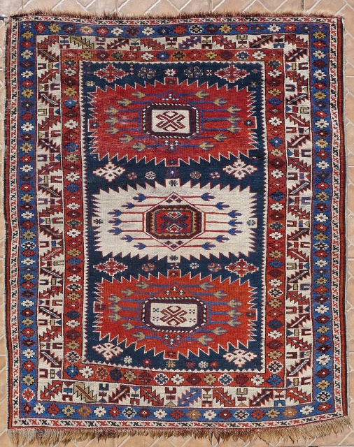 A antique Sunburst Zejwa Kuba rug, 150 x 125 cm (5.1ft x 4.1ft) late 19 th. century. The design with three large sunburst medallions.  Slight overall wear and minor corner damage  ...