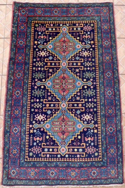 An Ugakh Kuba Rug, Divichi district, Azerbaijan. 158 x 96cm. (5.2ft x 3.15ft) ca. 1920/30 The dark blue field with
three stepped lozenges in sky blue, divided by golden yellow rods. Classic kufic  ...