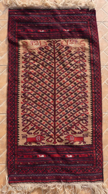 A Baluch flatwoven Balisht bagface,  ca. 1940- 1950
Tree of life design flanked by lions (Shir o Khorshid) motifs on a camel ground, natural dyed colours.       