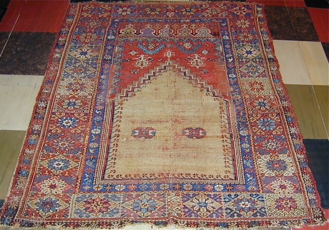 Mudjur prayer rug vertically cut and sewn back together  (see detail..Approx 2'' missing),65'' X 48''(165 X 123cm.),
18th. century.              