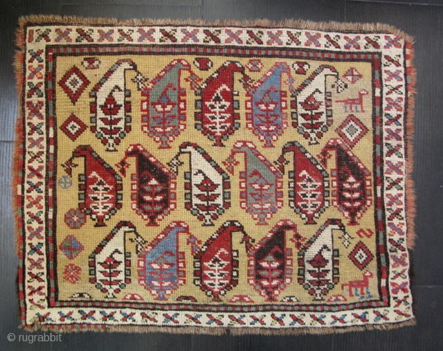 Yellow ground Karabagh mat, edges missing all around, all four sides invisibly stabilized.  Some well-done repiling,  approx. 26 x 33 inches.  SOLD        