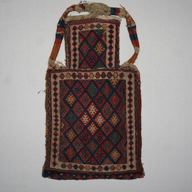 A finely woven Antique Kurd saltbag with original handle, made in E.Persia, circa 1910-1920 period. It has a nice band of carpet weave. It has original back with all natural dyes and ...