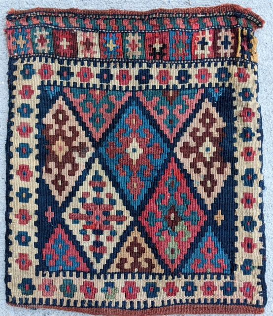 Lovely antique flat-woven chanteh (small personal bag), woven by a Kurdish tribe. Wonderful palette. Whimsical design flourishes on the back. Excellent condition with a full back. 43 x 36 cm.   