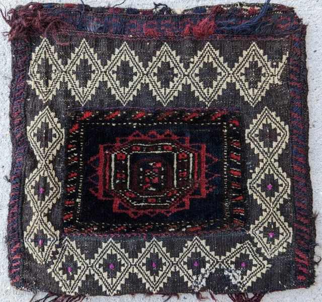 A fine Baluch chanteh, with mixed technique (piled knotting and various flatweave techniques). Silk highlights. Very uncommon. Good condition. Size: 13" x 13".          