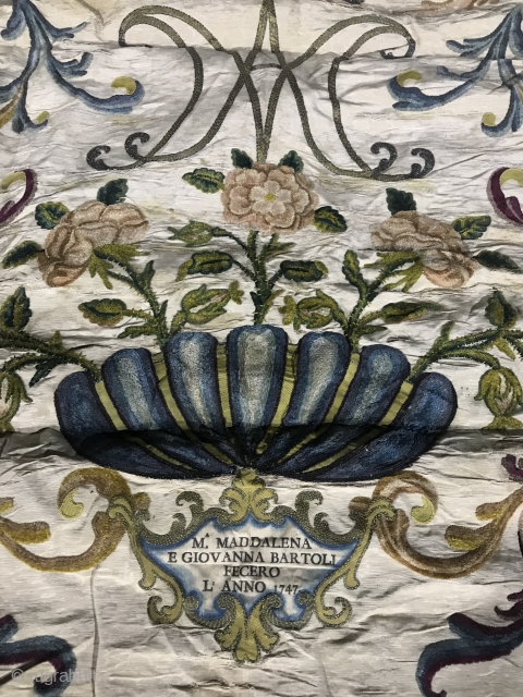 Mid 18th C Italian Textile

Floral cisele voided velvet pieces on cream silk. Silver metallic threads forming intertwined 
M A at top with a circle of stars. Velvet bowl at bottom with inset  ...