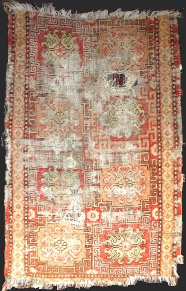 Khotan Rug, small format blossoms in lattice pattern with all natural colors. soft wool, evident wear and holes. Sourced recently in Tibet. 4"10' x 2'9" (146x81cm)       