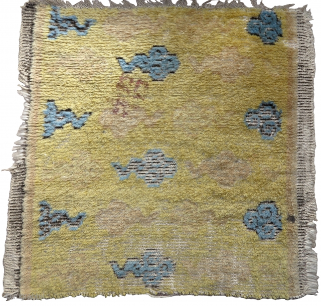 Early Chinese Ningxia fragment with cloud design. Weft is white animal hair not cotton. Either part of a runner, or based on size, perhaps a seating square. Super soft wool with large  ...