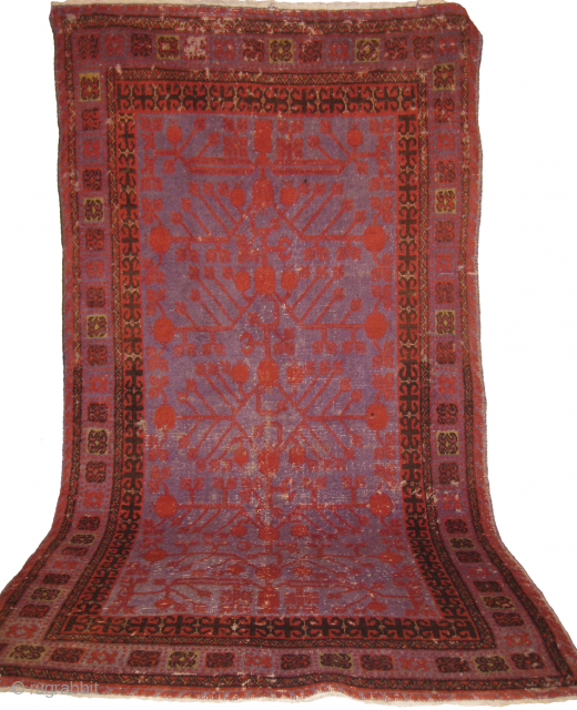 Khotan rug needs repair measuring 243 x 121 cm.                        