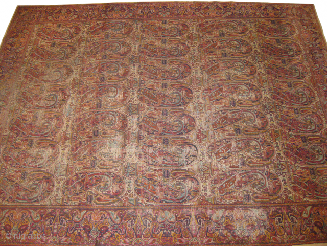 Indian paisley design old rug worn areas measuring 10 x 8 feet approx.                    