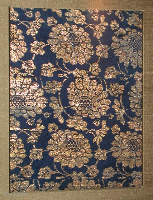 Chinese Textile	Ming dynasty	T380
9 1/2" x 7 1/4"        (1368-1644)

Repeating chrysanthemums decorate this textile.  The circular repeats formed by the floral stmes and leaves are typical  ...