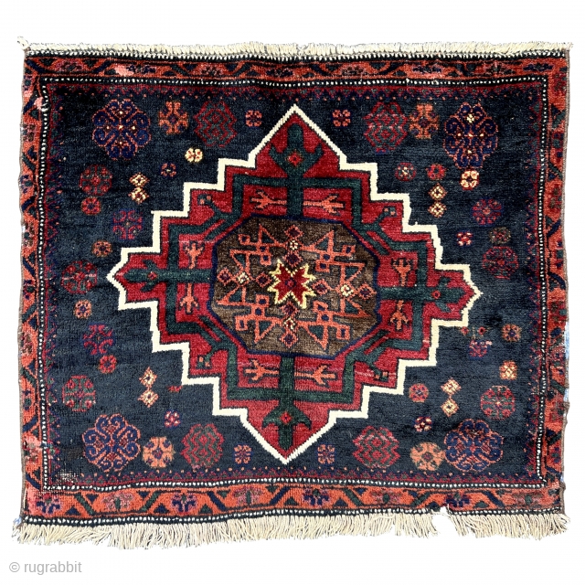 This Baluch bagface once formed part of a large khorjin. The midnight blue field contains a cruciform flower in an unusual shape reminiscent of snow crystals in the centre catches the eye.  ...