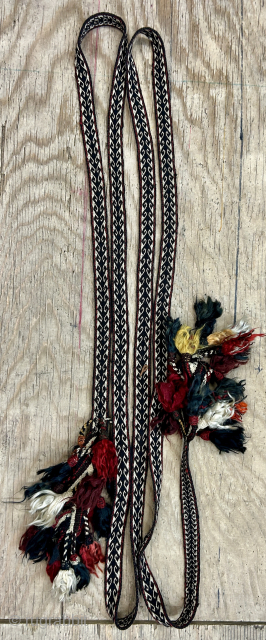 An impressive antique Qashqai narrow tent band. It seems to be for tying loads on camels and horses. The pom-poms at each end add so much charm to the piece and suggest  ...