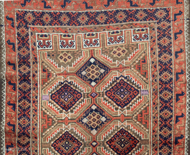 Decorative antique Baluch rug 163x95cm. The all over lozenge design on a light green background, with four niches at either end, is framed with a blue border and an interesting peacock terracotta  ...