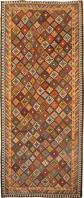 12941 Antique Bakhtiar Kilim 528x215cm Circa 1900 Magnificent antique Bakhtiar kilim. Multi coloured lozenge ground encased in a three layered border. Bakhtiar region is known for its use of natural dyes in  ...