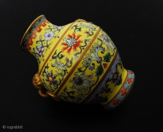 An important and very rare yellow-ground famille rose vase. iron-blue six-character sealmark and of the period (1796-1820)The vase of compressed pear-shape, elaborately decorated with four large blossoming lotus evenly spaced around the  ...
