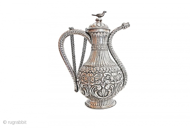 An ottoman silver ewer With squat body rising from short splayed foot to waisted neck with pronounced collar, the double curving spout with original stopper, the separate lid with faceted knop finial  ...