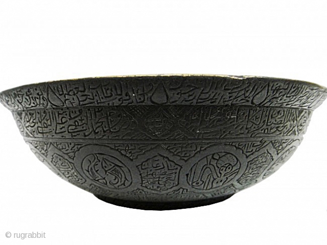 A PERSIAN / MUGHAL BRONZE MAGIC BOWL 

of deep rounded form supported on a raised foot, with narrow everted rim and raised omphalos with attached circular tray with pierced rim, the interior  ...