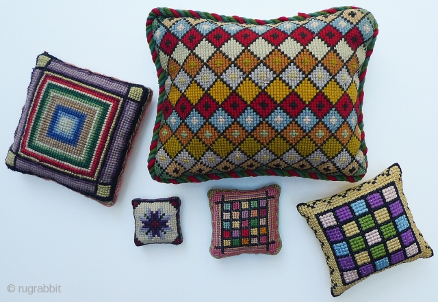 Collection of 5 Old Needlepoint Pincushions. Probably American. 7.5"x6"; 4.5"x4.5"; 3.75"x3.75"; 2.5"x2.5"; 1.75"x1.75". Some moth damage on the largest and the smallest one (as seen in photos) - rest in very good  ...