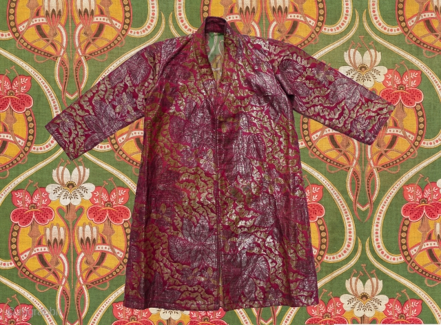 Uzbek Brocaded Boy's Robe. Russian silk brocade with gold and silver metallic threads. Russian Art Nouveau printed-cotton lining. Good condition except for some wear to the metallic threads; fading to the center  ...